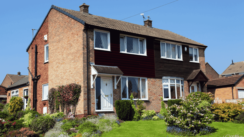 An image of a standard UK semi-detached house with uPVC windows and door