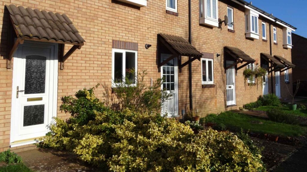 An image of a row of UK houses with uPVC doors